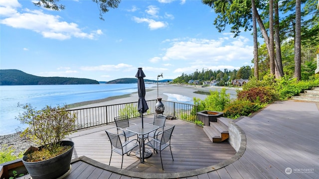 deck with a water and mountain view