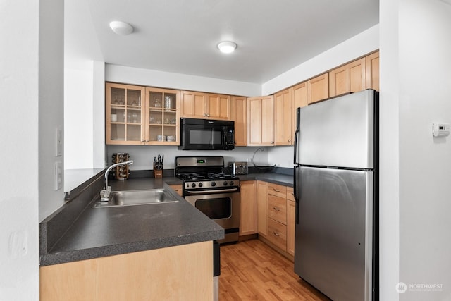 kitchen with sink, light hardwood / wood-style flooring, light brown cabinets, and appliances with stainless steel finishes