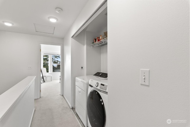 washroom with washing machine and dryer and light carpet