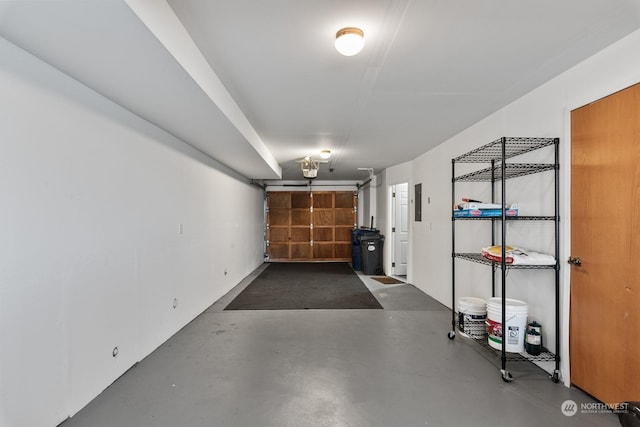 garage featuring electric panel and a garage door opener