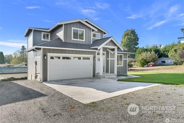 view of front of house with a garage and a front yard