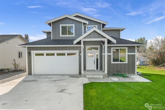 view of front of house featuring a front yard and a garage