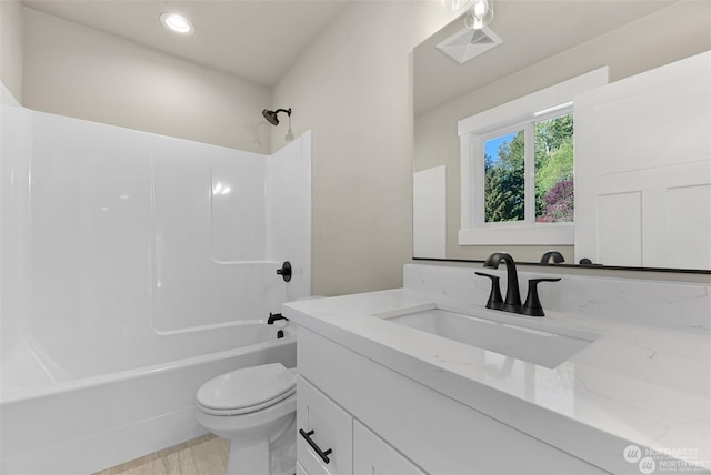 full bathroom featuring vanity, toilet, and  shower combination