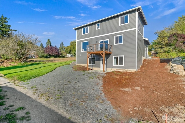 rear view of house featuring a deck