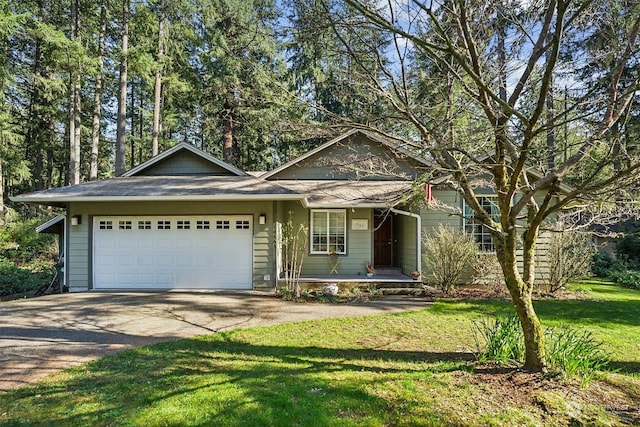 view of front of home with a garage and a front yard