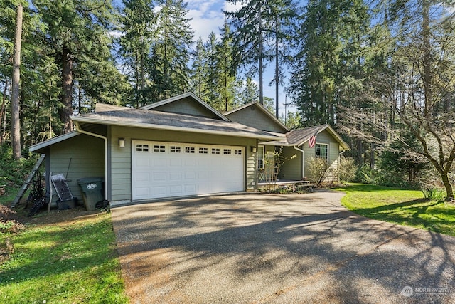 single story home featuring a garage and a front yard