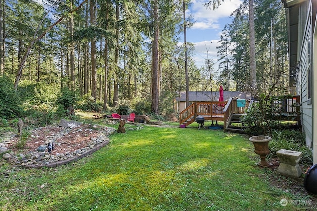 view of yard featuring a wooden deck