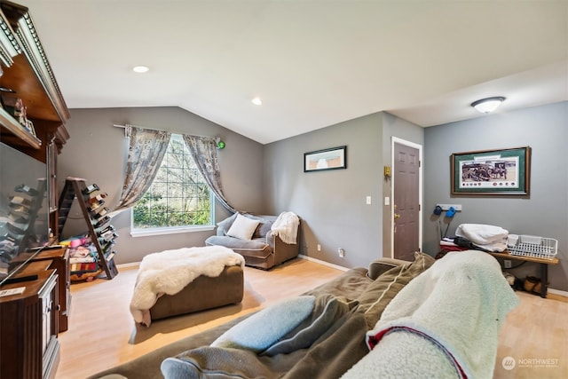 living room featuring light hardwood / wood-style flooring and vaulted ceiling