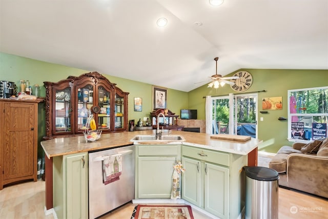 kitchen with a kitchen island with sink, sink, vaulted ceiling, stainless steel dishwasher, and light wood-type flooring