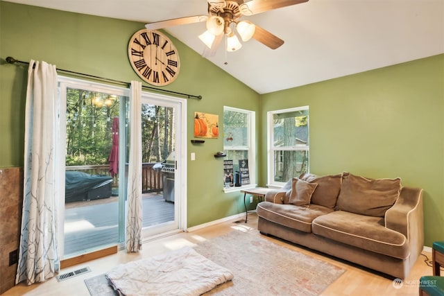 living room featuring ceiling fan, light hardwood / wood-style floors, lofted ceiling, and a wealth of natural light