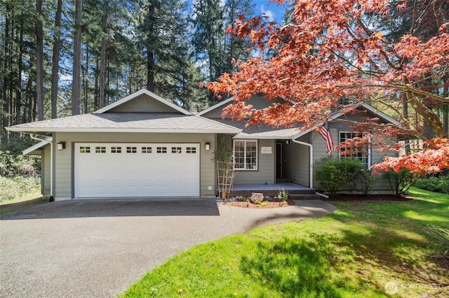 10405 Olympic Pl, Anderson Island, WA 98303 - view of front of house with driveway, a porch, a garage, a shingled roof, and a front yard