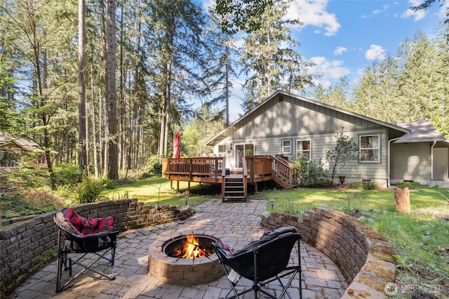 10405 Olympic Pl, Anderson Island, WA 98303 - back of house with a patio area, a fire pit, a yard, and a wooden deck