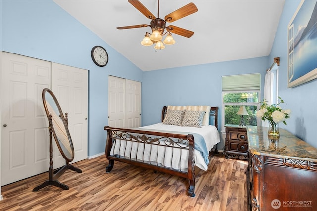 10405 Olympic Pl, Anderson Island, WA 98303 - bedroom featuring wood finished floors, lofted ceiling, a ceiling fan, baseboards, and multiple closets