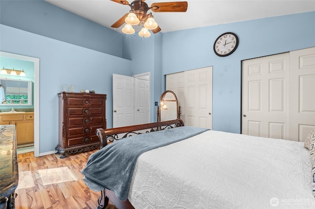 10405 Olympic Pl, Anderson Island, WA 98303 - bedroom with light wood finished floors, a high ceiling, ceiling fan, two closets, and connected bathroom