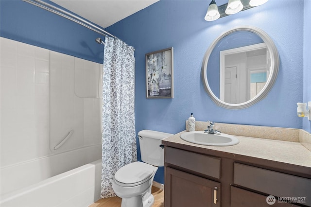 10405 Olympic Pl, Anderson Island, WA 98303 - bathroom with shower / tub combo, toilet, wood finished floors, and vanity