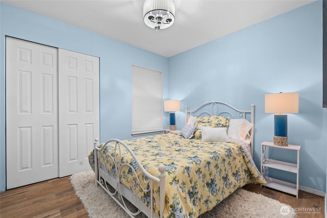 10405 Olympic Pl, Anderson Island, WA 98303 - bedroom featuring wood finished floors, a closet, and baseboards
