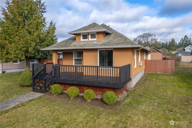 view of front of home with a wooden deck and a front lawn