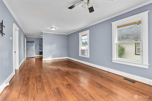 spare room featuring hardwood / wood-style floors, ceiling fan, and ornamental molding