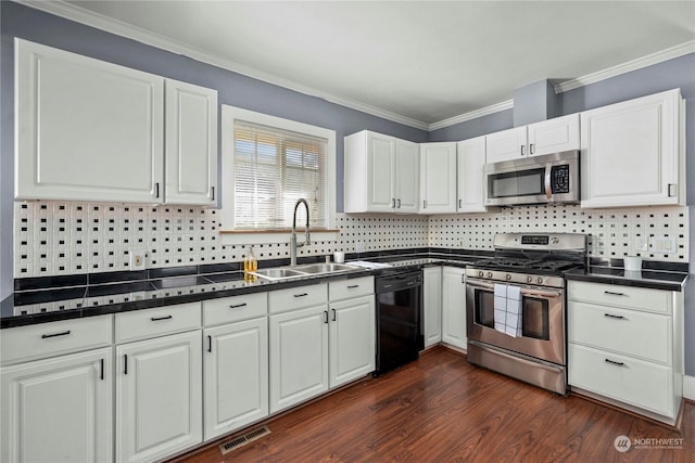 kitchen featuring sink, stainless steel appliances, white cabinets, and tasteful backsplash