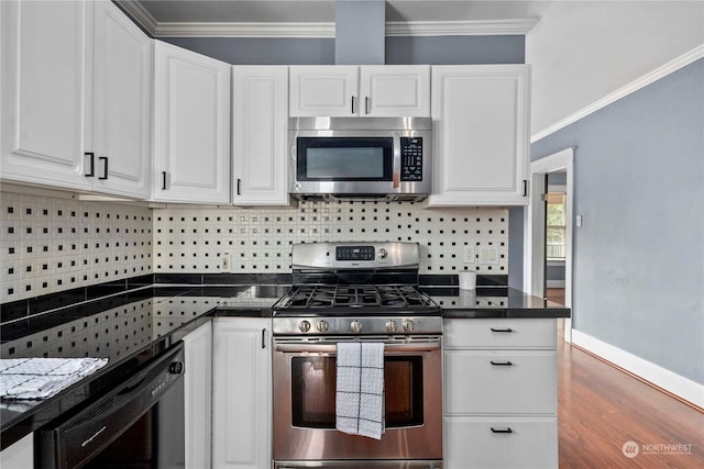 kitchen featuring crown molding, appliances with stainless steel finishes, hardwood / wood-style floors, white cabinetry, and decorative backsplash