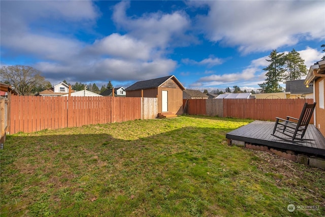 view of yard with a storage unit and a deck