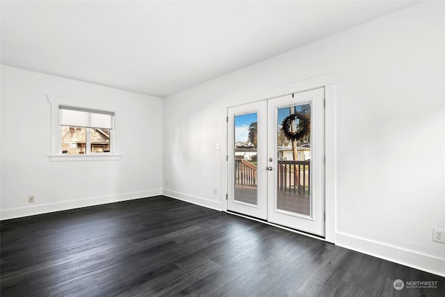 spare room with french doors and dark hardwood / wood-style floors