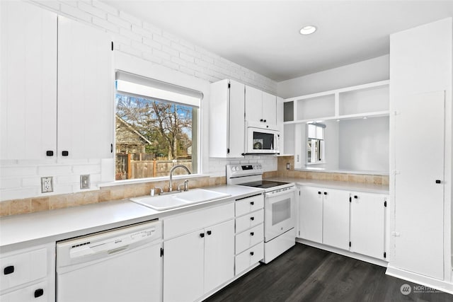 kitchen with dark hardwood / wood-style flooring, sink, white cabinetry, tasteful backsplash, and white appliances