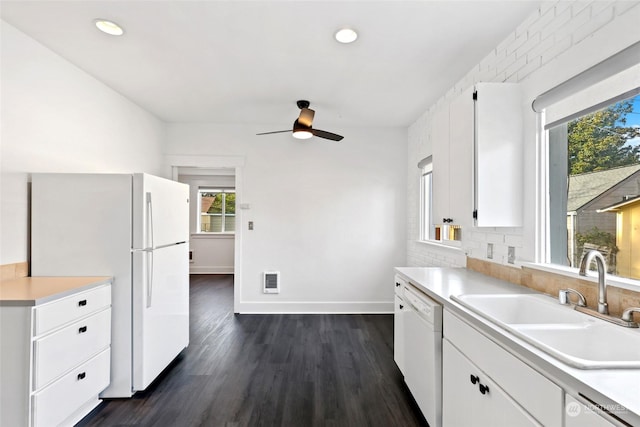 kitchen with white cabinets, white appliances, dark wood-type flooring, and sink