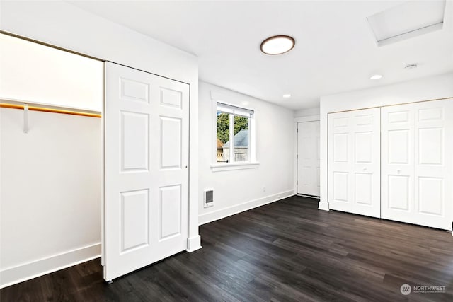 unfurnished bedroom featuring dark wood-type flooring