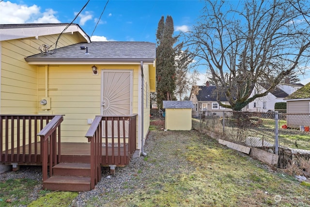 exterior space with a deck and a shed