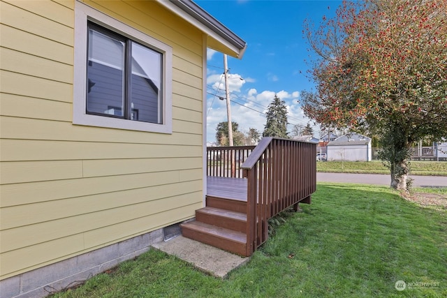 wooden terrace featuring a yard