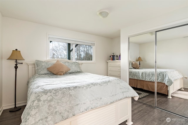 bedroom with dark hardwood / wood-style floors and a closet