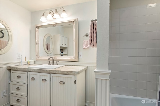 bathroom with vanity and a tub