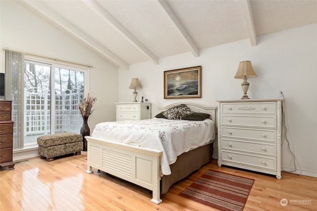 bedroom featuring lofted ceiling with beams, light hardwood / wood-style flooring, and multiple windows