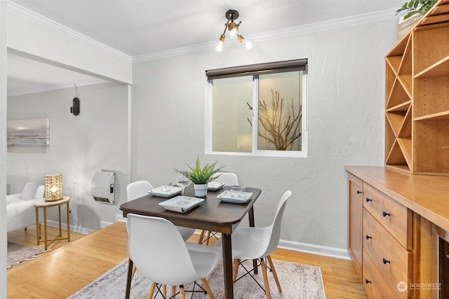 dining area featuring light hardwood / wood-style floors and ornamental molding