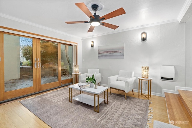 living area with hardwood / wood-style floors, ceiling fan, crown molding, and french doors