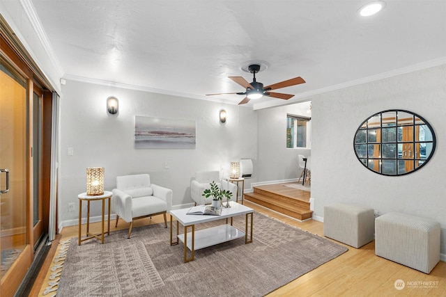 living room featuring crown molding, hardwood / wood-style floors, and ceiling fan