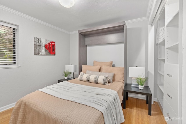 bedroom featuring light hardwood / wood-style floors and crown molding