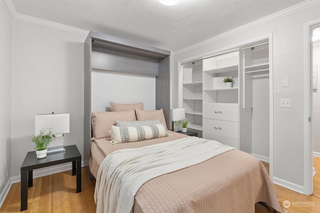 bedroom with crown molding and light hardwood / wood-style flooring