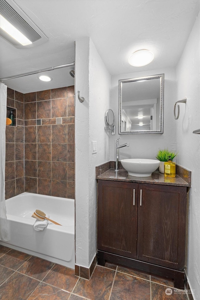 bathroom featuring vanity and shower / bathtub combination with curtain