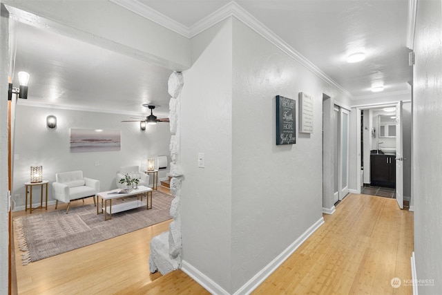 hall with hardwood / wood-style floors and crown molding