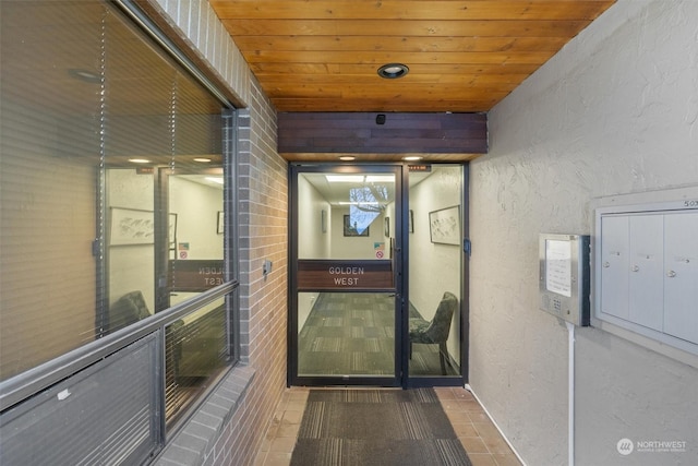 hall with mail boxes, tile patterned flooring, and wooden ceiling