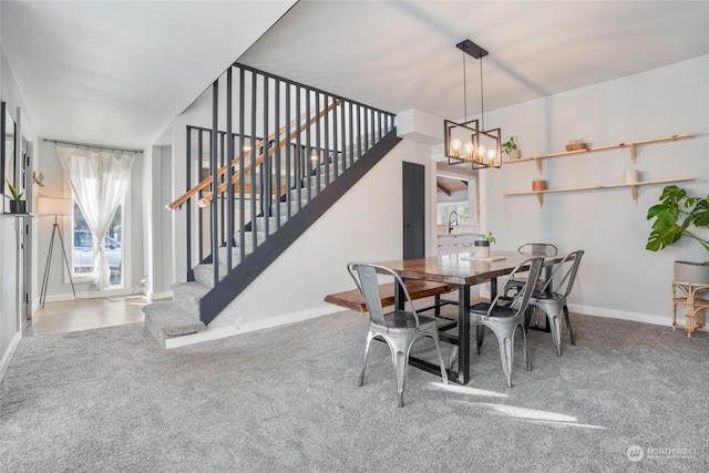 dining space with carpet floors, sink, plenty of natural light, and a chandelier