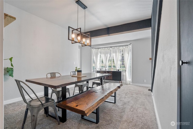 carpeted dining room featuring an inviting chandelier