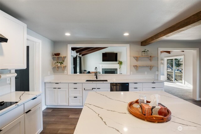 kitchen featuring light stone counters, sink, white cabinets, and dishwasher