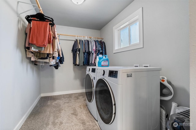 laundry room featuring washing machine and clothes dryer and light carpet