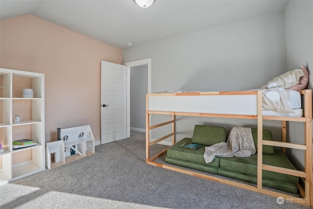 carpeted bedroom with lofted ceiling