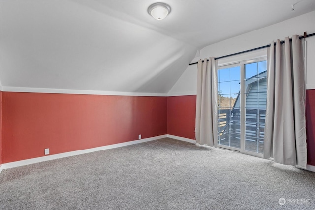 bonus room with lofted ceiling and carpet floors