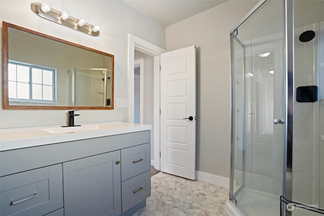 bathroom with vanity, a shower with shower door, and tile patterned floors