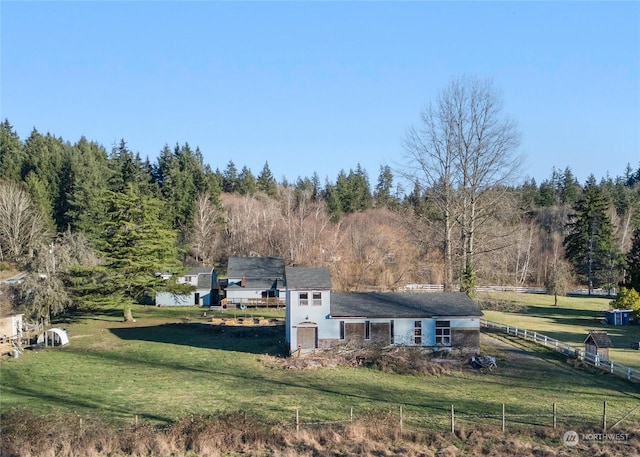 exterior space featuring a rural view and a yard